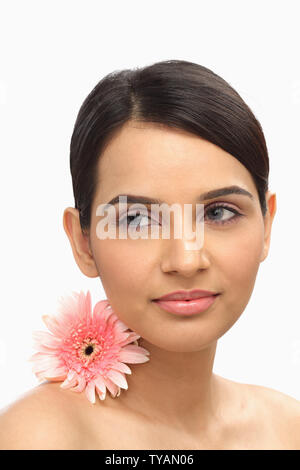 Close up of a woman with flower on her neck Stock Photo