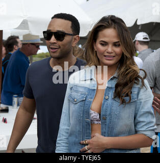 Il cantautore John Legend e sua moglie di Sports Illustrated cover model Christine Teigen presso la seconda annuale di celebrity chef torneo di pallavolo tra gli sport illustrato 2014 modelli di costume da bagno e top chef professionisti in Miami Beach, Florida, 20 febbraio, 2014. UPI/Gary mi Rothstein Foto Stock