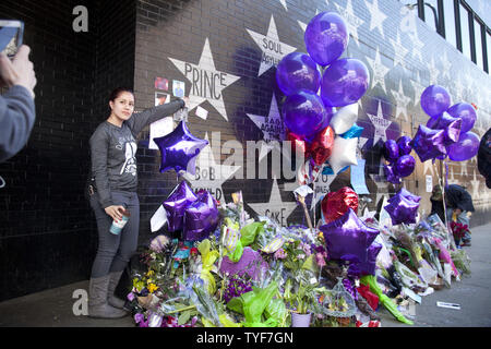 Ventilatori per rendere omaggio al principe (nato Prince Rogers Nelson) al di fuori del night club, First Avenue, dove il viola uno ha iniziato la sua carriera in aprile 22, 2016 a Minneapolis, Minnesota. Il principe è morto il 21 aprile all'età di 57. Foto di Marilyn Indahl/UPI Foto Stock