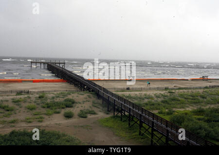 Onde generate dall uragano Alex può essere visto dietro una diga di tiger posizionato per mantenere l'olio fuori dalla spiaggia in Grand Isle, Louisiana Giugno 30, 2010. L'olio è stato perde nel Golfo del Messico a partire dal mese di aprile quando una massiccia esplosione sulla BP oil rig Deepwater Horizon ha creato il peggio spill nella storia degli Stati Uniti. UPI/A.J. Sisco Foto Stock