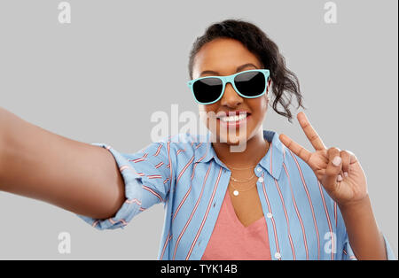 African American woman in occhiali da sole prendendo selfie Foto Stock