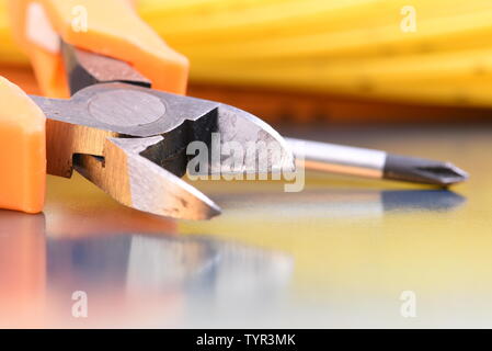 Primo piano gli strumenti e i cavi utilizzati nelle apparecchiature elettriche di installazione a casa Foto Stock