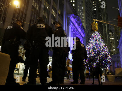 I funzionari di polizia del NYPD la lotta contro il terrorismo stand gruppo intorno al nuovo albero di Natale illuminato vicino al NYSE alle cerimonie per la 93annuale di albero di Natale Illuminazione dopo il closing bell presso il New York Stock Exchange su Wall Street a New York City il 1 dicembre 2016. Il Dow Jones Industrial Average chiuso a 19,191.93 fino 68 punti a un nuovo tutti i tempi di alta. Foto di Giovanni Angelillo/UPI Foto Stock