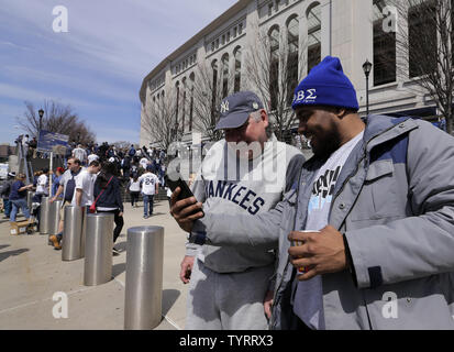 Eddy Stokes (R) mostra Kevin Tracy, che è vestito come Babe Ruth, la sua immagine dopo lo scatto di una foto in Babe Ruth Plaza prima della New York Yankees in apertura di giornata MLB gioco con il Tampa Bay Rays allo Yankee Stadium di New York City, 10 aprile 2017. Foto di Ray Stubblebine/UPI Foto Stock