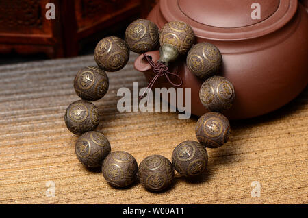 Seta dorata Namu Yin legno affondata stringa a mano perline di Buddha Foto Stock