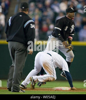 Chicago White Sox' secondo baseman Juan Uribe (R) salta per evitare lo scorrimento dei Seattle Mariners' Miguel Cairo (C) nella terza inning al Safeco Field di Seattle, 11 aprile 2008. I marinai Beat the White Sox 6-3. (UPI foto/Jim Bryant) Foto Stock