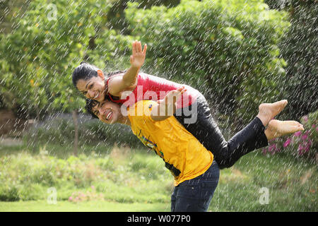 Couple romancing in the rain Stock Photo