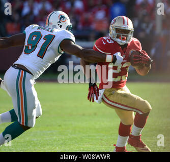 San Francisco 49ers LaMichael James (23) cerca di eludere i delfini di Miami Cameron Wake (91) nel terzo trimestre al Candlestick Park di San Francisco il 9 dicembre 2012. Il 49ers sconfitto i delfini 27-13. UPI/Terry Schmitt Foto Stock