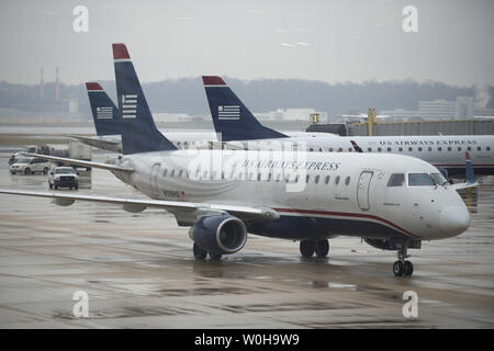 Aerei taxi sulla pista sotto la pioggia all'Aeroporto Nazionale Ronald Reagan, Novembre 26, 2013, in Arlington, Virginia. Le difficili condizioni atmosferiche, che dovrebbe interessare la maggior parte del paese nei prossimi due giorni, ha il potenziale di causare enormi ritardi per viaggiatori in vacanza. UPI/Kevin Dietsch Foto Stock