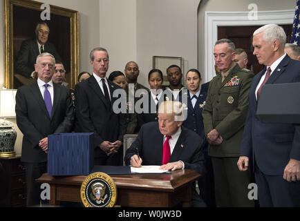 Presidente Donald Trump segni H.R. 2810, la difesa nazionale atto di autorizzazione per l'anno fiscale 2018, durante una cerimonia di firma nella sala Roosevelt su dicembre 12, 2017 a Washington D.C. Trump era unita da, da sinistra a destra il Segretario della Difesa, Jim Mattis, Presidente della Casa Comitato delle Forze Armate del Mac Thornberry, R-TX, Presidente del Comune di capi di Stato Maggiore Joseph F. Dunford, Vice Presidente Mike Pence e membri dei militari. Foto di Kevin Dietsch/UPI Foto Stock