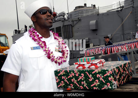 I sistemi di informazione tecnico 2a classe Ryan Jurode si diparte la Pearl Harbor-base missile guidato fregata USS Reuben James (FFG 57) con regali di Natale durante la nave del ritorno alla stazione navale Pearl Harbor, Dicembre 19, 2008. (UPI foto/Michael A. Lantron/DOD) Foto Stock