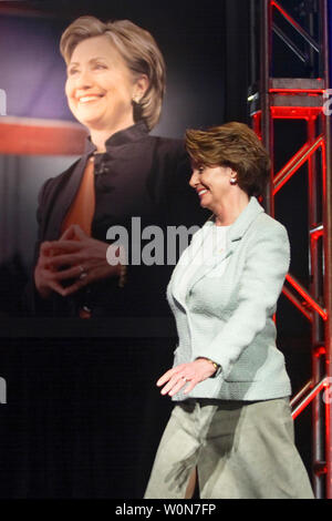 Presidente della Camera Nancy Pelosi (D-CA) passa un poster di presidenziale democratico speranzoso il senatore Hillary Clinton (D-NY) prima di affrontare l'Emily's elenco pranzo annuale a Washington il 6 marzo 2007. (UPI foto/Kamenko Pajic) Foto Stock