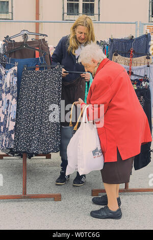St. Pölten, Niederösterreich, Österreich, Wochenmarkt. Bild zeigt Verkaufsgespräch am Kleiderstand. Foto Stock