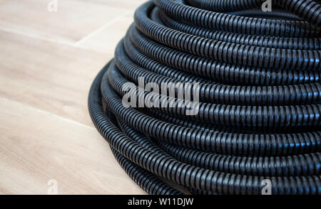 Nero tubo corrugato per il cavo. È usato per installazioni elettriche. Foto Stock