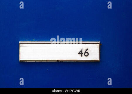 Casa numero 46 con il forty-sei in nero su argento set letterbox su un blu della porta anteriore Foto Stock