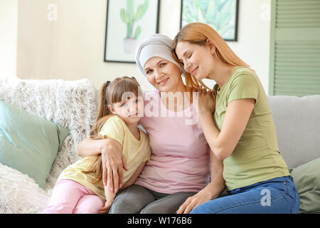 Donna matura dopo la chemioterapia con la sua famiglia a casa Foto Stock