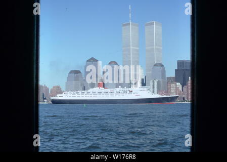 QE 2 lasciando la città di New York nel 1988 passando per il World Trade Center e la parte inferiore di Manhattan, New York. Foto Stock