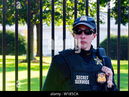 Washington D.C., USA, ottobre 2016: un giovane ufficiale indossando occhiali da sole e l'uniforme dei servizi segreti americani a guardia della Casa Bianca nel lavare Foto Stock