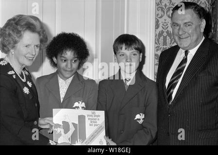 Il Primo Ministro Margaret Thatcher a fianco di Carla verde, 11, e Giles Morrison, 13, gli alunni di Prato Emscote scuola preparatoria in Warwick e Sir David McNee, Regno Unito presidente della Royal Life saving Society, al 10 di Downing Street presso il lancio della società di acqua della campagna di sicurezza. Una cartella speciale sulla sicurezza dell'acqua viene inviata a 30.000 scuole in tutto il Regno Unito per aiutare a portare verso il basso il numero di giovani che annegano in Gran Bretagna ogni anno. Foto Stock