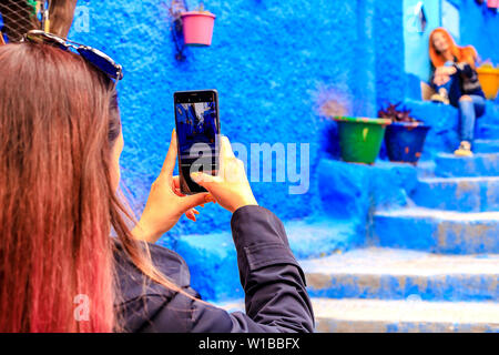 Chefchaouen, Marocco - 24/04/2019: turisti fotografare a Chefchaouen, una bellissima città del nord del Marocco e visitata da turisti provenienti da tutto il w Foto Stock