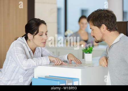 Segretario accogliente al client Office reception Foto Stock