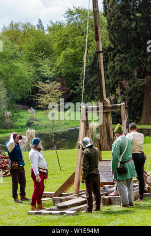 La gente in costume medievale dimostrando un trebuchet Foto Stock