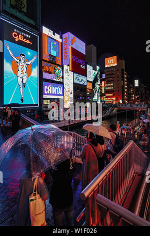 Area Dotonbori luci e la riflessione durante la pioggia Foto Stock