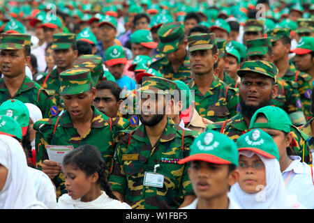 I membri delle forze di sicurezza di partecipare all'evento intitolato "Lakho Konthe Shonar Bangla". Oltre 2,5 lakh persone chorus l inno nazionale a livello nazionale P Foto Stock