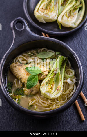 Zuppa di pollo al curry verde tailandese con pak choi e funghi Foto Stock