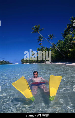 Mann schwimmt im Meer, un piede Isola, Aituaki Lagune Cook-Inseln Foto Stock