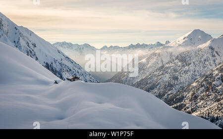 Piccolo rifugio nella luce della sera vicino a Moldongrat, pesantemente coperto di neve paesaggio invernale, Alpi Lechtal, Tirolo, Austria Foto Stock