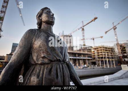 Statua di fronte all Opera, sito in costruzione e gru in background, la Nuova Opera House di Oslo, Norvegia, Scandinavia, Europa Foto Stock
