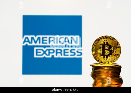 Oro Bitcoin monete con la American Express logo su sfondo dello schermo. Un nuovo tipo di business finance concetto. Foto Stock