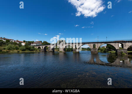 Vista del vecchio ponte sul fiume Lima presso il villaggio di Ponte da Barca nella regione del Minho del Portogallo. Foto Stock