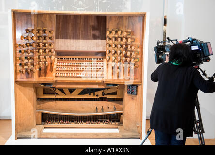 Amburgo, Germania. 04 Luglio, 2019. Una camerawoman è ripresa nel Museum für Kunst und Gewerbe nella mostra Manufaktur des Klangs. Duemila anni di organaria organo e la riproduzione di un organo. Più di 30 mostre, tra cui 14 strumenti storici e ricostruzioni, vi invitano a conoscere la progettazione strutturale e la raffinatezza tecnica dell'organo Wunderwerk nella mostra. Credito: Daniel Bockwoldt/dpa/Alamy Live News Foto Stock