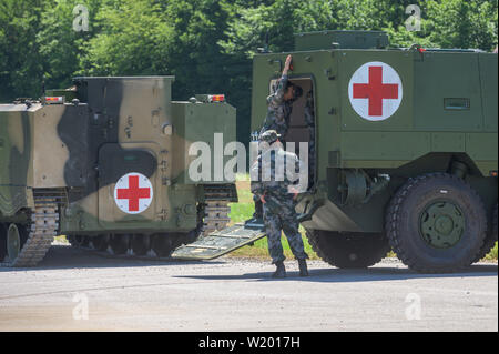 Feldkirchen, Germania. 04 Luglio, 2019. I soldati del popolo cinese della Esercito di Liberazione stand presso le ambulanze blindate dalla Cina. Medical soldati del popolo cinese della Esercito di Liberazione hanno avviato un esercizio con la Bundeswehr in Baviera. Fino al 17 luglio, lo scenario di una comune missione ONU saranno addestrati a Feldkirchen nella Bassa Baviera. Credito: Armin Weigel/dpa/Alamy Live News Foto Stock