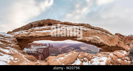 Visualizzazione classica del famoso Mesa Arch, simbolo del sud-ovest americano, illuminata a scenic golden. La luce del mattino al sorgere del sole su una bella giornata invernale in Foto Stock