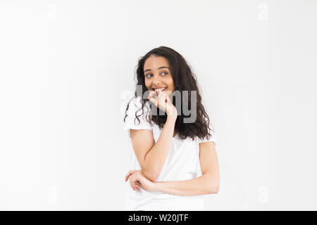 Close up ritratto di affascinante e bella giovane donna guarda lontano tenere la mano sul mento isolato su sfondo grigio con copia spazio per il testo. Foto Stock