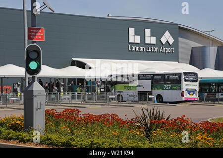Dall' Aeroporto di Luton a Londra. Il passeggero drop-off, area e la stazione degli autobus di fronte all'edificio del terminal principale - con nuovo logo (estate 2019) Foto Stock