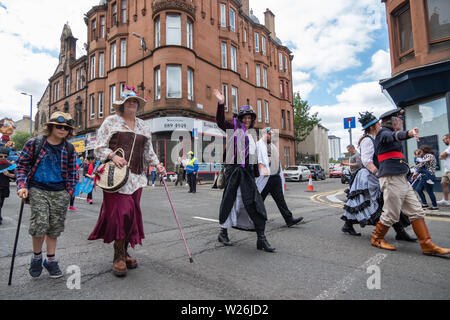 Paisley, Scozia, Regno Unito. 6 Luglio, 2019. Membri del Glasgow onnipresente E. Steampunk celebra la società Sma' Shot giorno in parata in viaggio attraverso le strade di Paisley da Brodie Park a Paisley Arts Center. Sma' Shot giorno che prende il nome da una famosa vittoria tra il scialle tessitori e il sughero (l'uomo centrale) nel XIX secolo. La sma' shot è un sottile filo di trama, tessute in Paisley scialli dai tessitori, per cui essi non sono stati pagati. Nel 1856 un accordo è stato raggiunto finalmente a pagare per la SMA' shot . Credito: Berretto Alamy/Live News Foto Stock