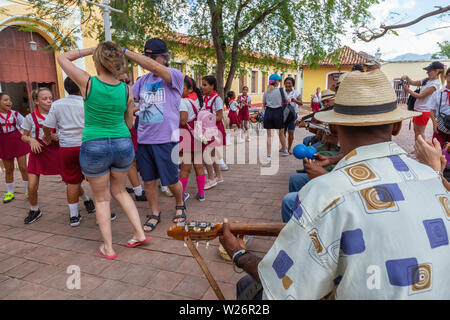 Trinidad, Cuba - Giugno 6, 2019: la gente ballare con la musica dal vivo per le strade di una piccola città cubane durante una vivace giornata di sole. Foto Stock