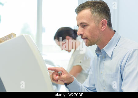 Elegantemente vestito uomo dell'apparecchiatura di programmazione Foto Stock