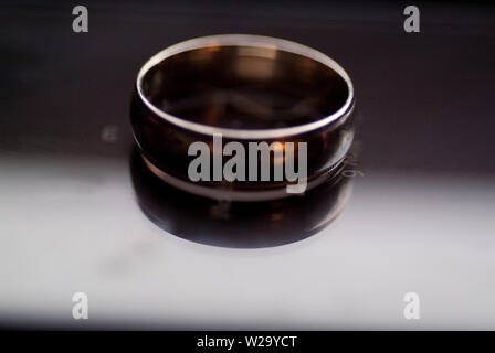 Il impegnato un anello di fidanzamento si siede in cima a un cellulare di visualizzazione di data e ora. Foto Stock