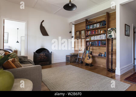 Soggiorno in villetta con pavimenti in legno e pannello reggiate di soffitto e ingresso alla camera da letto Foto Stock