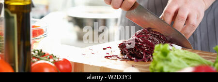Chef professionale le mani per affettare il cavolo viola Foto Stock