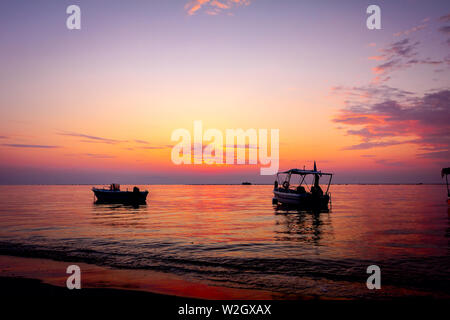 Stagliano shot della bellissima alba con barche di pescatori sull'acqua Foto Stock