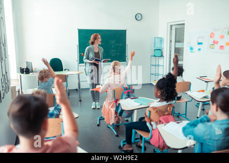 Insegnante di matematica chiamando un alunno alla lavagna. Foto Stock