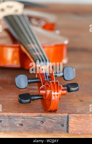 Close up di un violino shallow profondità di campo su uno sfondo di legno Foto Stock