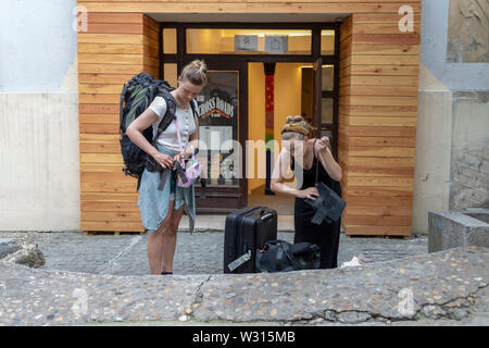 A Belgrado, in Serbia il 5 Luglio 2019: scena urbana con due giovani donne i viaggiatori che arrivano in corrispondenza di uno dei city ostelli Foto Stock