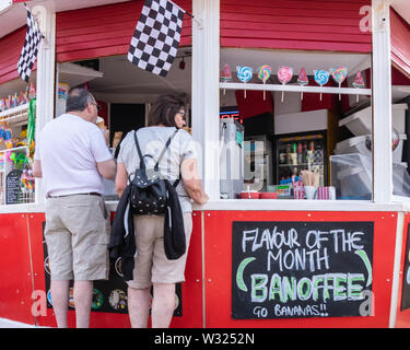 Un giovane in un mare di gelato in stallo Foto Stock